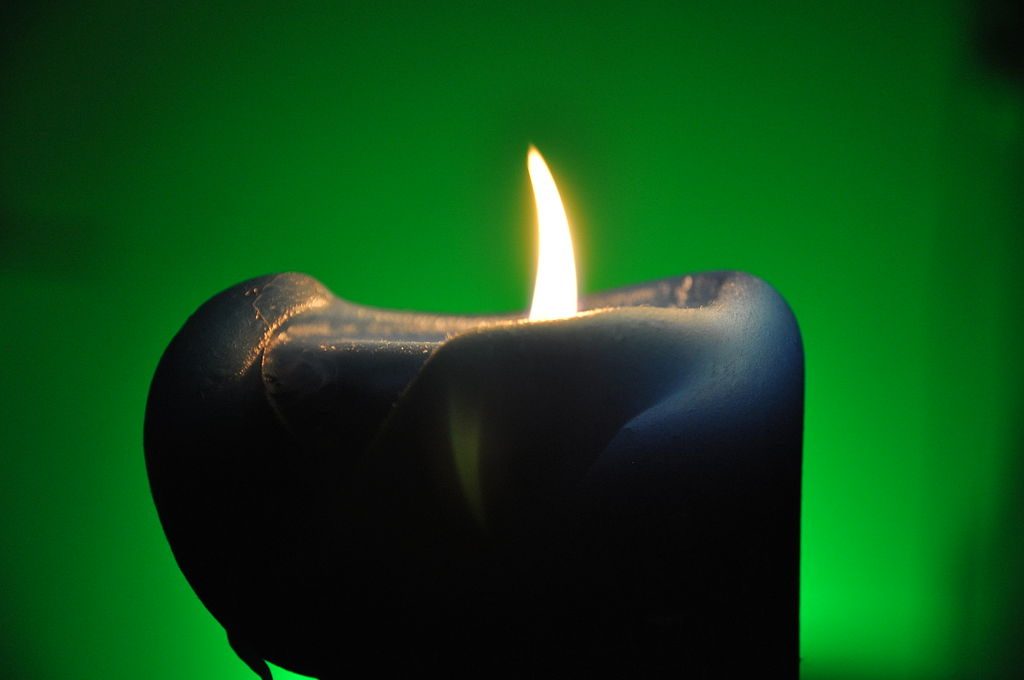 Candle with green light. Onderwijsgek - Own work, Emerald Candle of Growth