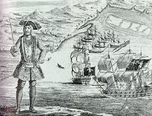 Bartholomew Roberts with his ship and captured merchant ships in the background. A copper engraving[1] from A History of the Pyrates by Captain Charles Johnson c. 1724