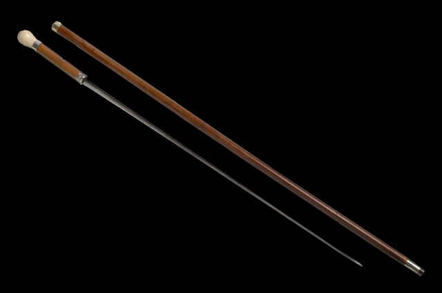 Wooden cane with a concealed sword inside.  Sword cane
