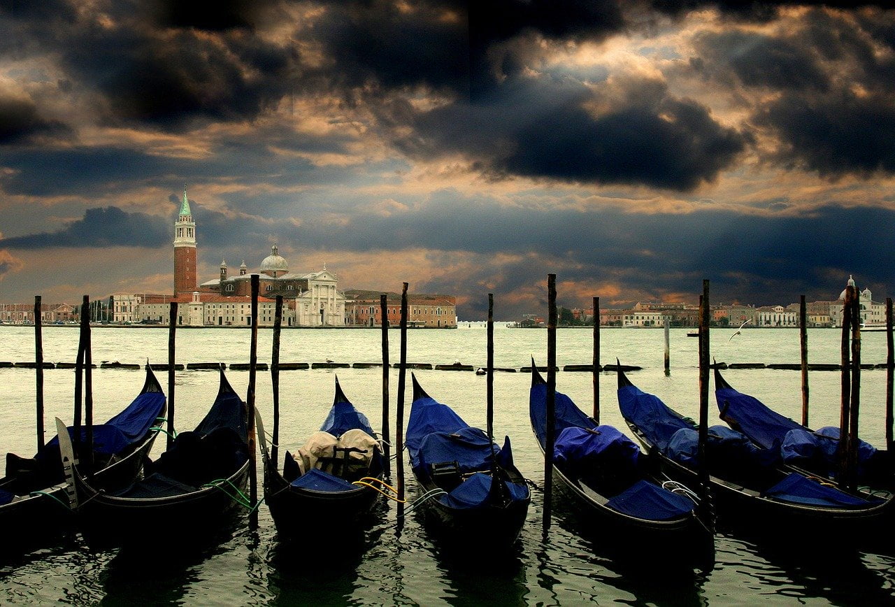 Gondolas and waterfront buildings in the Venetian lagoon