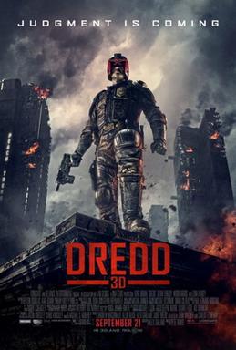 A futuristic police officer in armour and a helmet that covers all but his mouth stands on the corner of a building roof with a gun in his hand as large tower blocks burn behind him. Above the man reads a tagline 
