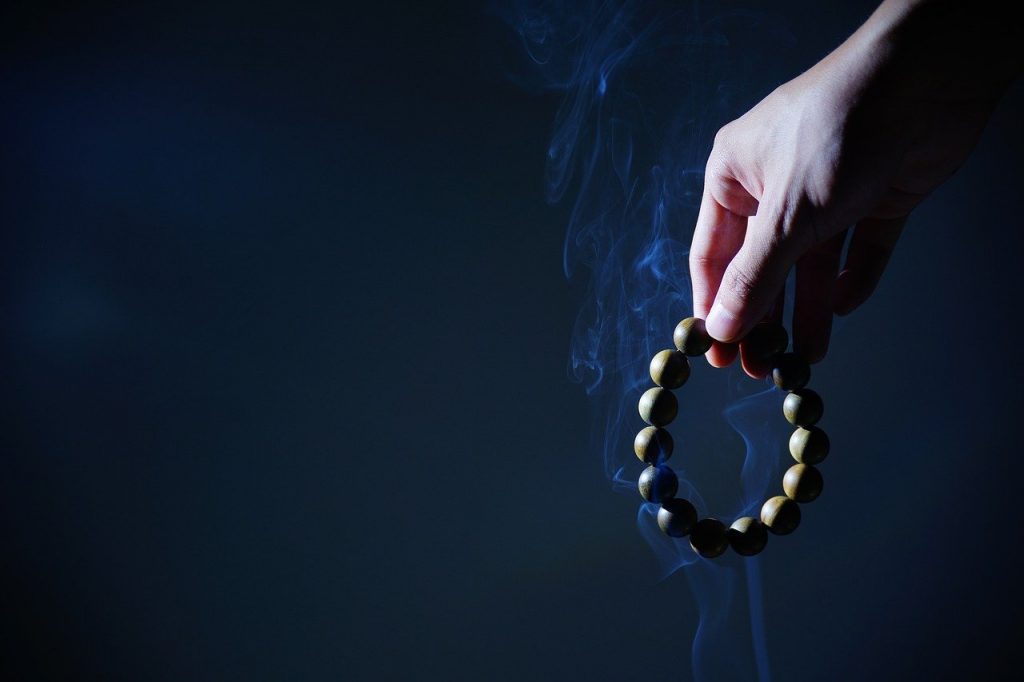 Strand of Prayer Beads, hand, buddhist prayer beads, smoke